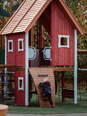 Ein Spielplatzsystem aus Holz und Rot, das einen rustikalen Charme versprüht.